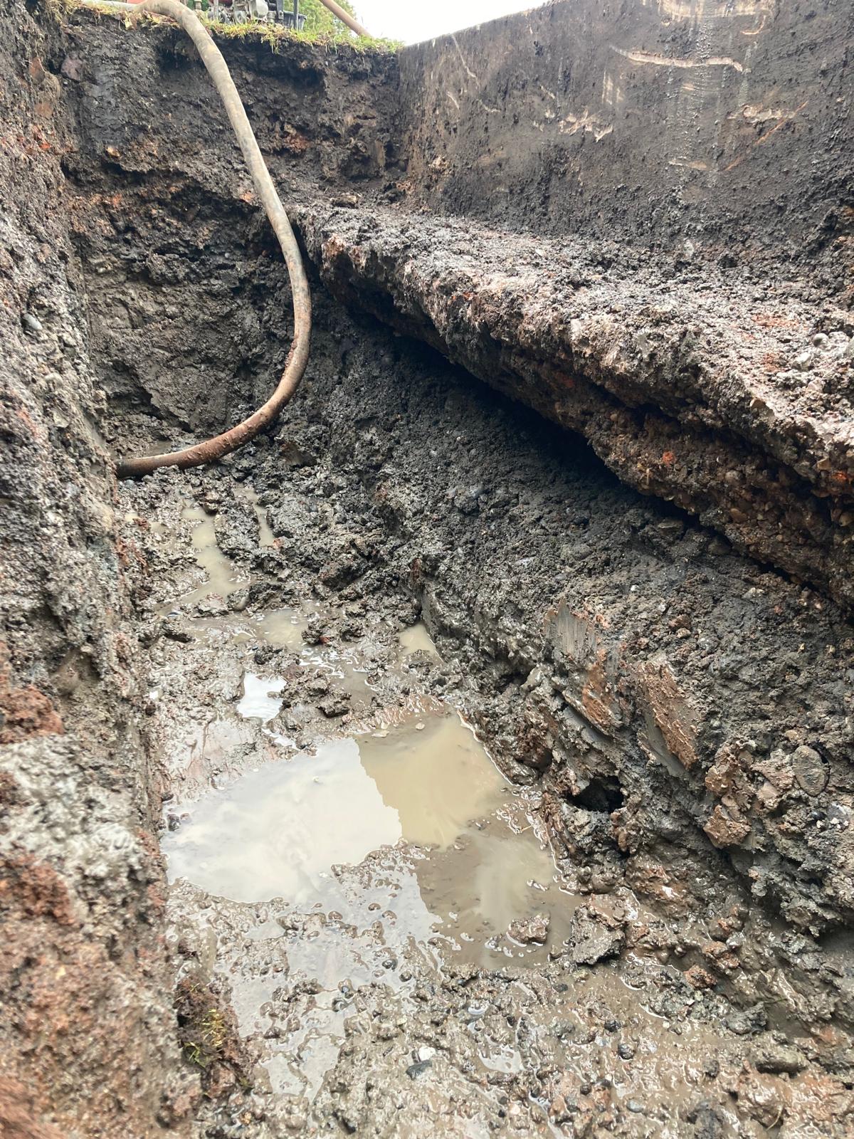 Photo showing excavated section of wall foundation and the void found - supporting image