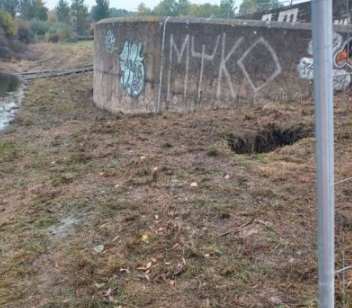 Photos showing overflow level of spillway and sinkhole on upstream bank after water drawn down - supporting image