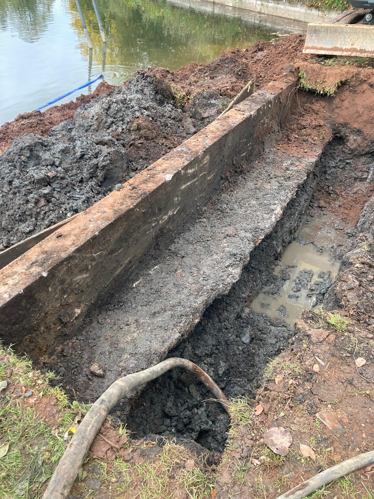 Photo showing excavated section of wall foundation and the void found - supporting image