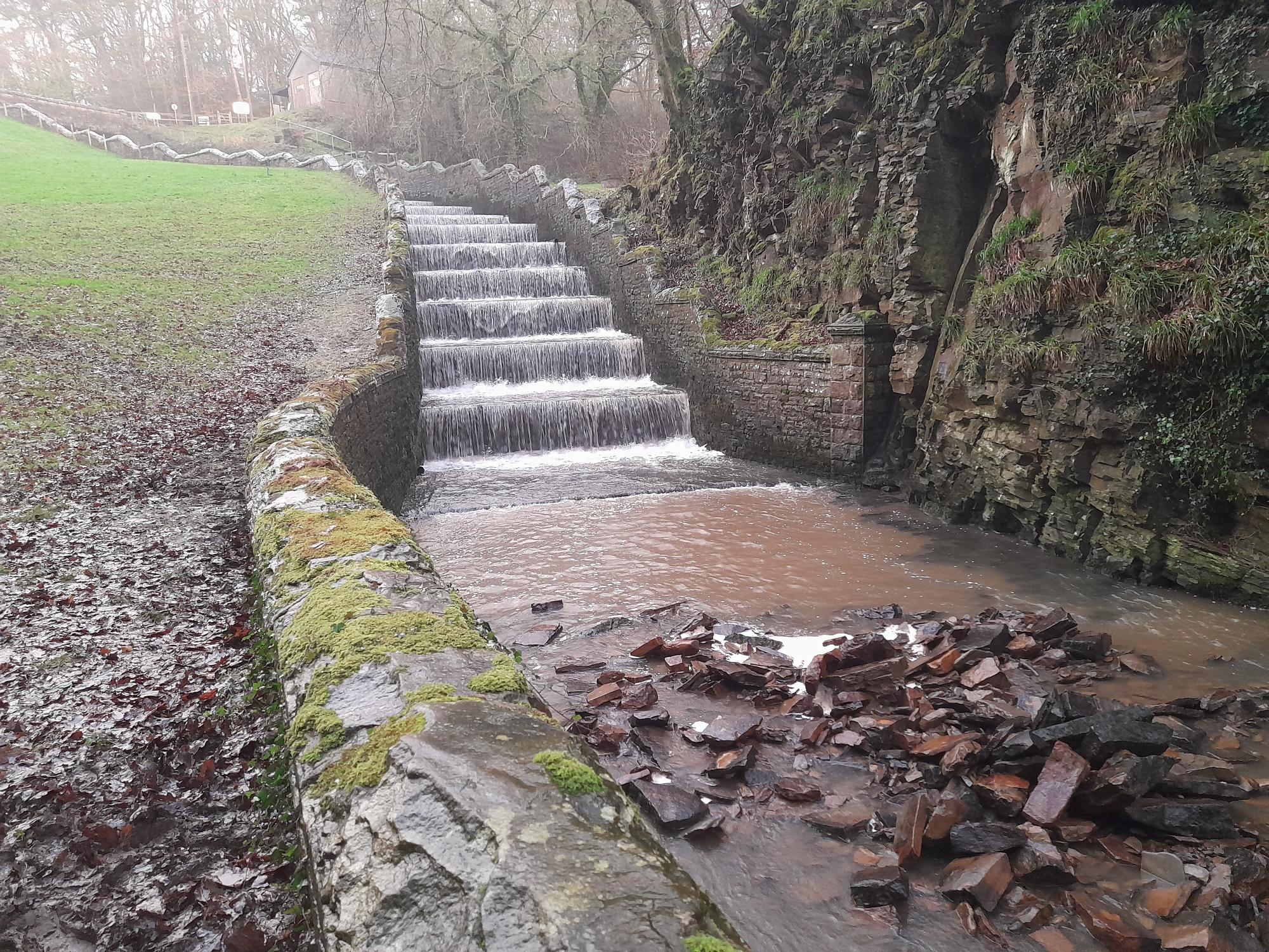 Area at toe of spillway with dark water showing loss of masonry lining - supporting image